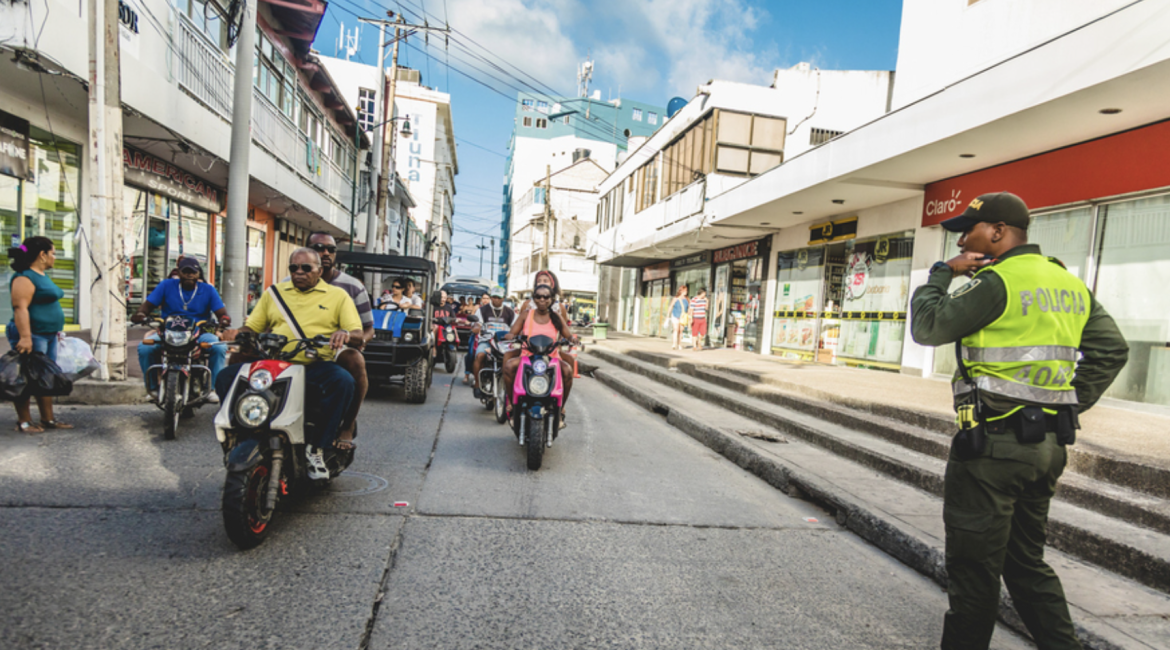 A police officer and commuters in downtown San Andres Island, Colombia, March 2017